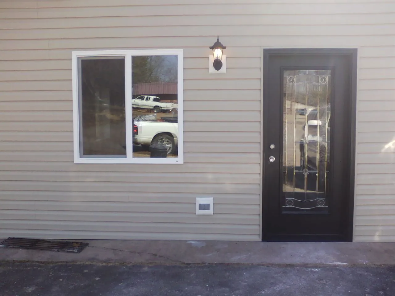New siding, window and entry door on the side of an addition in Lewiston